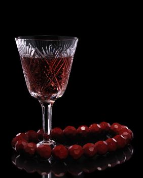 Wine. A glass vessel with wine, a red grape drink