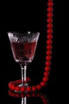 Wine. A glass vessel with wine, a red grape drink