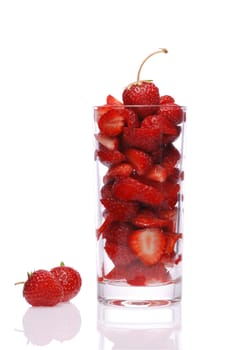 Glass with the cut strawberry. It is isolated on a white background