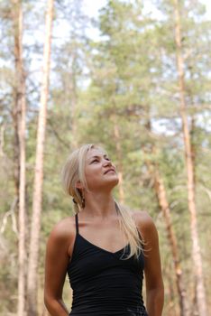 The girl  blonde. In a black blouse and a happy smile on the person