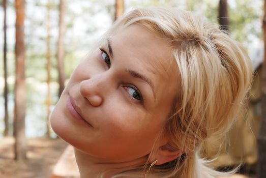 The girl  blonde. In a black blouse and a happy smile on the person