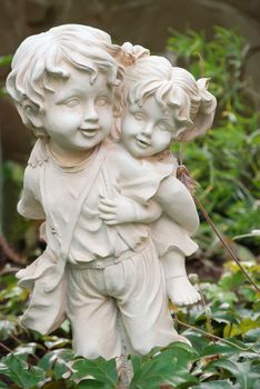 Sculpture of the boy and the girl. The brother bears ����� on a back