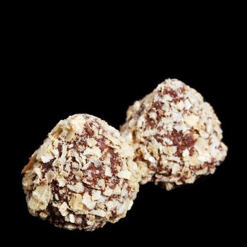 Sweets - a truffle. Isolated on a black background