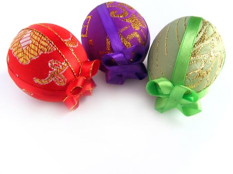 Easter eggs tied up by tapes - a surprise (handmade) - isolated white background