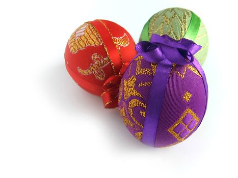 Easter eggs tied up by tapes - a surprise (handmade) - isolated white background