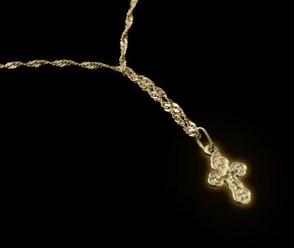 gold chain with a dagger glow. The crucifixion