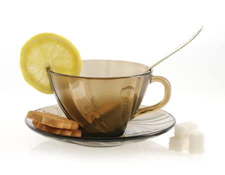 empty glass transparent cup, spoon, suggar and lemon. Heat-tolerant utensils 