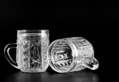 Two crystal glass with reflection isolated on a black background
