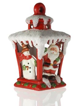 Christmas toy. A toy on a fur-tree with porcelain Santa Claus and snowman