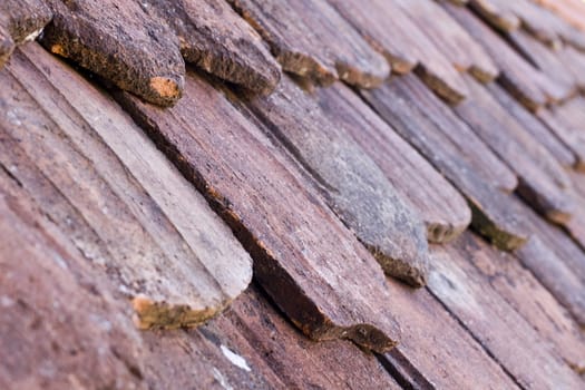 old historic roof. roof tiles in different shapes