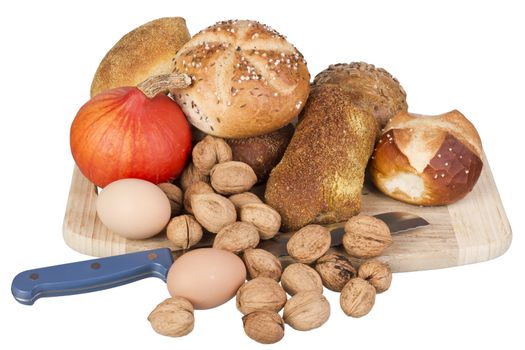 gem, nuts, eggs and a pumpkin on a wooden board. isolated on white background