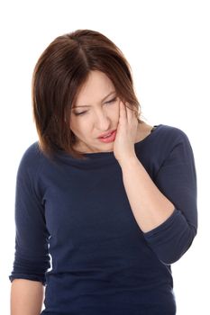 Attractive woman in her 40s pressing her bruised cheek with a painful expression as if she's having a terrible tooth ache.