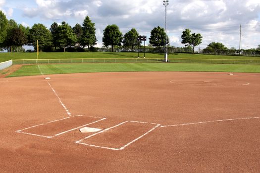 A view of a softball diamond at dusk.
