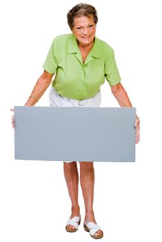 Mature woman showing a placard and smiling isolated over white