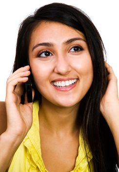 Happy woman talking on a mobile phone isolated over white