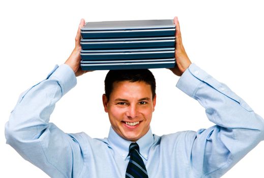 Smiling businessman holding a stack of laptops isolated over white