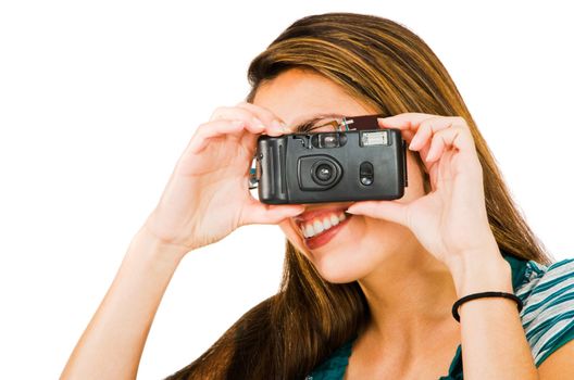 Beautiful woman photographing with a camera and smiling isolated over white