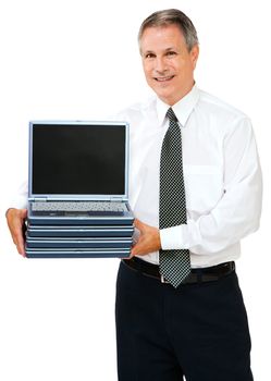 Businessman holding a stack of laptops isolated over white