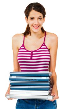 Confident woman holding a stack of laptops isolated over white