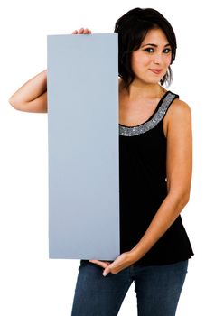 Gorgeous woman showing an empty placard isolated over white