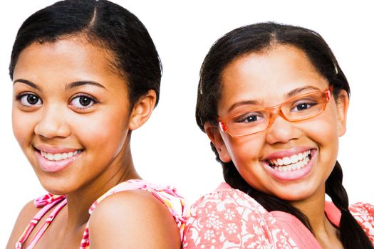 Close-up of two teenage girls smiling isolated over white