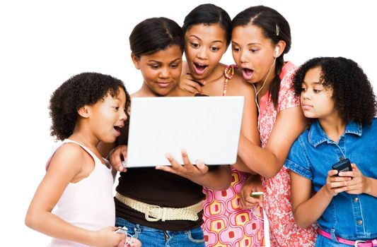 Shocked friends using a laptop isolated over white