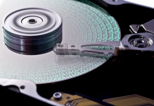 hard disk drive in close up with data on disk. head in motion