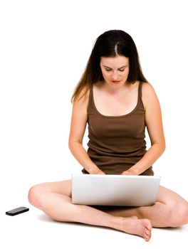 Woman using a laptop isolated over white