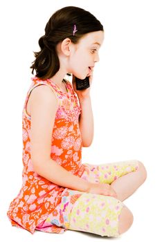 Caucasian girl talking on a mobile phone isolated over white