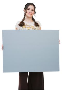 Woman holding a placard and smiling isolated over white