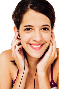 Confident woman listening to music on earbud isolated over white
