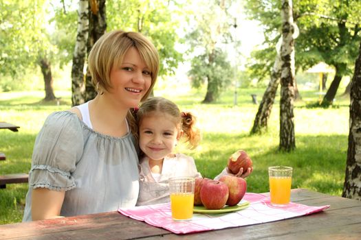 mother and daughter breakfast in nature