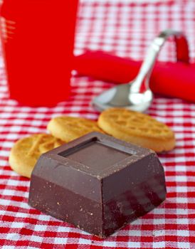 Close up of biscuits and chocolate on red and white cloth