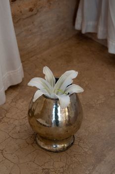 White Lily flower aranged in vase in beautiful spa interior