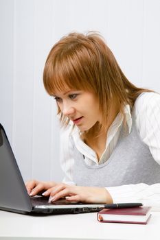 curious attractive girl looks in the laptop monitors