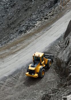 Construction machine in a dark rocky area