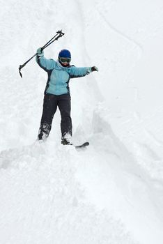 Skier coming down on an off-piste slope with fresh snow