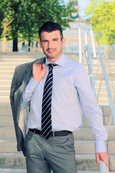 standing businessman waiting outdoor in autumn on stairs