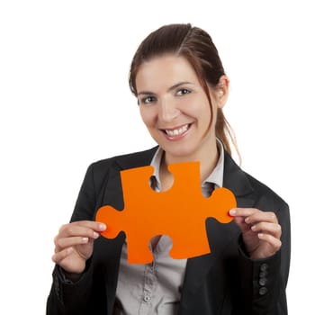 Business woman holding a big puzzle piece, isolated on white