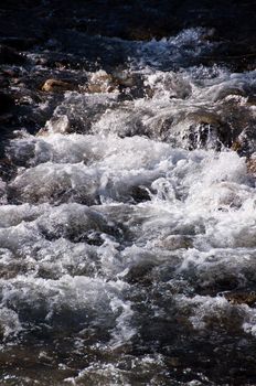 Mountain stream with falls from Hintertux Glacier in Zillertal, Austria
