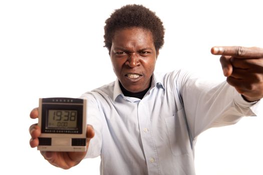 a young man looking angry pointing on a clock