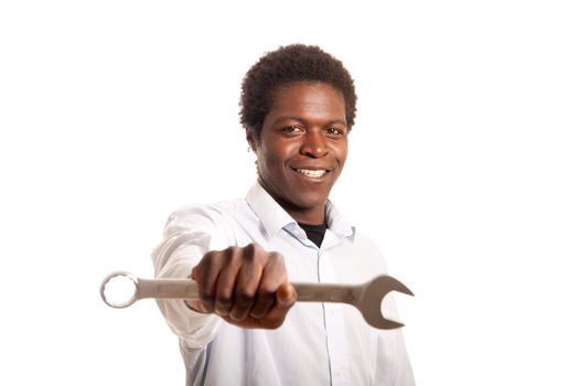 a young black man showing a wrench