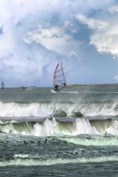 surfers windsurfing in the maharees in county kerry ireland during a storm