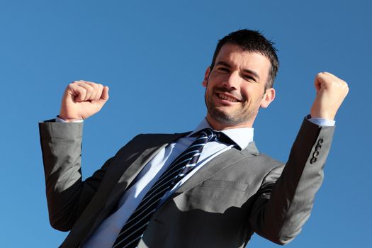 handsome businessman in blue sky in summer