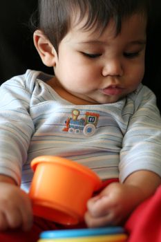 Baby playing with colorful cups