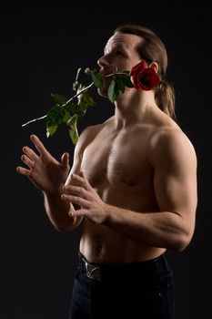 standing romantic man with red rose
