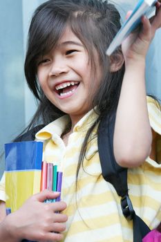 Girl excited about her new schoolbooks