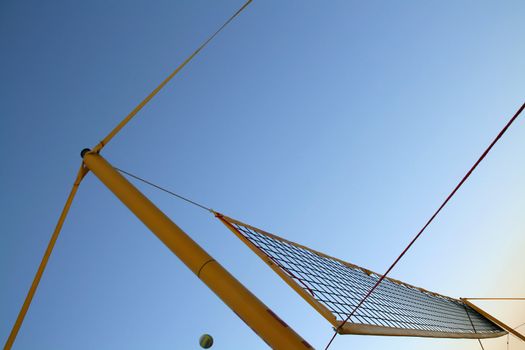 yellow beach volley ball net, blue sky background