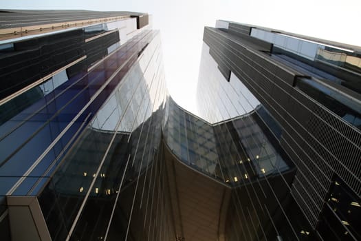 Business building, blue glass, white sky background
