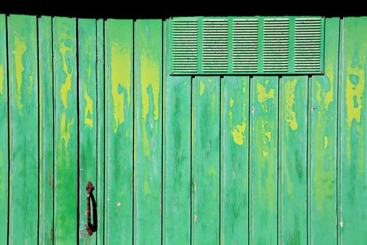 old green and yellow garage door, crusty and rusty